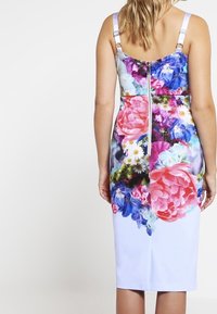 Floral dress with a zip closure at the back. Features vibrant colors, including pink, blue, and white, with a fitted design and adjustable straps.