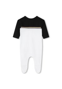 Romper per bambini bianco e nero con maniche lunghe, parte superiore nera in tinta unita, parte inferiore bianca e accento a righe dorate sulla schiena. Materiale in cotone morbido.