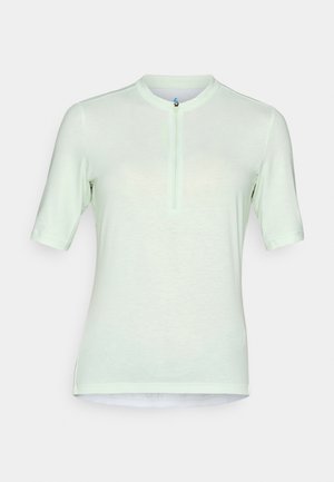 Chemise vert clair à manches courtes avec un col montant et une fermeture éclair à l'avant, fabriquée dans un tissu doux et respirant. Design ajusté avec des coutures plates.