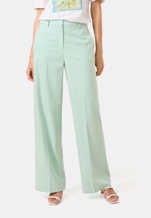 Light mint green wide-leg trousers in a textured fabric, featuring a flat front, belt loops, and a tailored fit. Paired with a casual white t-shirt.