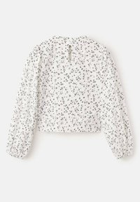 Bluza albă cu imprimeu floral negru, design cropped, mâneci lungi bufante, decolteu rotund și închidere la spate cu șnur. Textură fină.