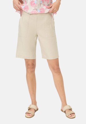 Beige Leinen-Shorts mit vorderen Patten Taschen, knielangem Design und atmungsaktivem Material, kombiniert mit hellbraunen Riemchensandalen.