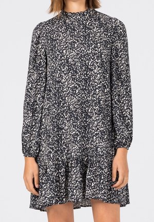 Robe navy avec un motif abstrait blanc, manches longues, col haut et ourlet évasé. Tissu léger au toucher doux.