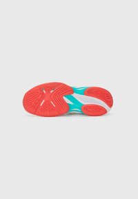 Athletic shoe sole in turquoise and white with a textured red rubber tread. Notable circular and wavy patterns for traction.