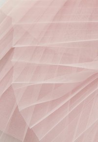 Svetloružová tylová látka, priehľadná a mäkká, s prekríženým vzorom a vrstvenými záhybmi, vytvárajúc textúrovaný vzhľad.