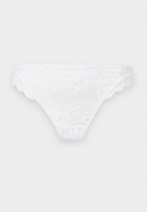 Hvid blondekvindelig bikiniunderbukser med blomstermønstre og bølgede kanter på en lysegrå baggrund.