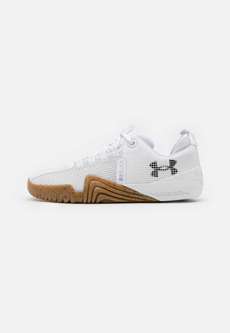 White athletic shoes featuring a mesh upper, rubber outsole with a gum color, textured accents, and a black logo on the side.