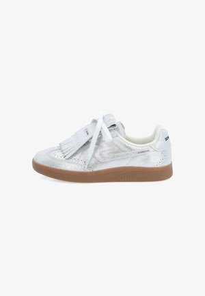 Silver leather sneaker with a chunky gum sole, featuring decorative fringes on the tongue and white laces. Smooth upper texture, perforated design.