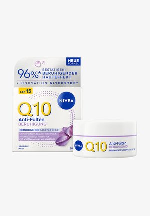 Nivea Q10 anti-wrinkle soothing day cream with SPF 15 in white jar and box, featuring purple flower graphic and product claims in German.