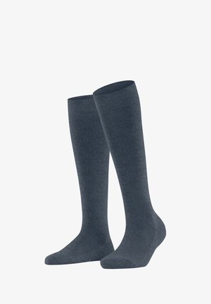 Chaussettes montantes de couleur bleu foncé, avec une texture lisse et uniforme et des poignets côtelés pour un maintien sécurisé. Fabriquées à partir d'un matériau doux et extensible.