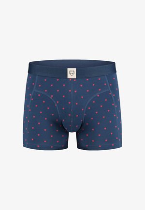 Tumed bokserid pehmest kangast, millel on hajutatud punaste südamete muster ja ühtlane vöökoht koos logo silmaga esiosas.