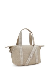 Bolso de hombro beige con estampado, doble asa y correa ajustable, cremallera plateada y el nombre de la marca "Kipling" en las correas.
