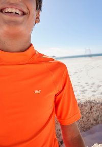 Next - SHORT SLEEVE SUNSAFE  - Majica za zaščito pred izpuščaji in odrgninami - orange Miniaturna slika 1