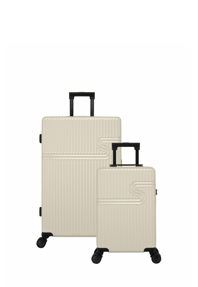 Lichtbeige harde koffer set, met verticale ribbels, zwarte telescopische handvatten en soepele wielen. Inclusief een grotere en een kleinere maat.