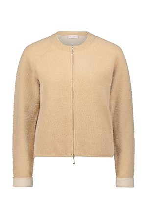 Beige sweater met ritssluiting en een zachte, gestructureerde afwerking. Heeft raglanmouwen en geribde manchetten. Strak, eenvoudig ontwerp met een ronde hals.