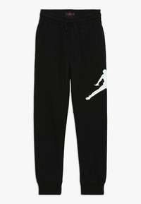 Pantalones de chándal negros hechos de algod�ón con una cinturilla elástica. Logotipo Jumpman blanco notable en el muslo izquierdo. Puños ajustados en los tobillos.