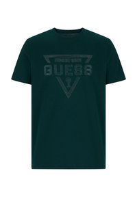Ciemnozielona bawełniana koszulka z trójkątnym czarnym logo oraz napisami "GUESS" i "SINCE 1981" na przodzie.