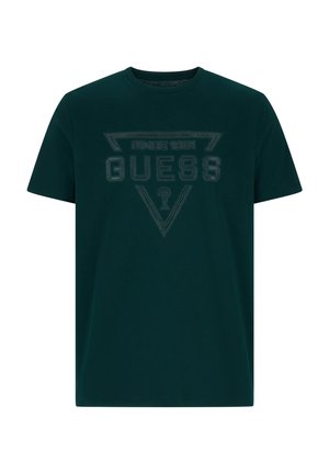 Ciemnozielona bawełniana koszulka z trójkątnym czarnym logo oraz napisami "GUESS" i "SINCE 1981" na przodzie.