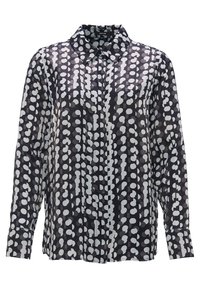 Chemise noire à manches longues avec col et motifs abstraits blancs en points disposés en lignes verticales.
