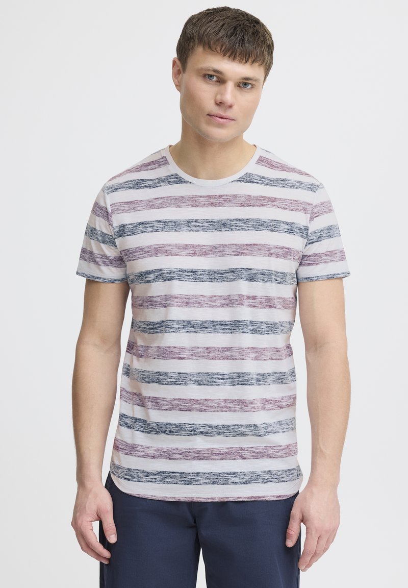 Striped short-sleeve t-shirt in light fabric, featuring wide horizontal stripes in purple, blue, and white. Round neckline, relaxed fit.
