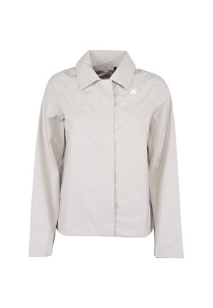 Giacca da donna grigio chiaro con maniche lunghe, colletto appuntito, chiusura frontale nascosta e piccolo logo bianco sul petto sinistro.