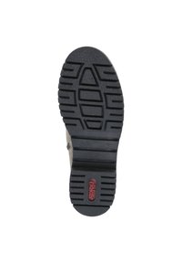 Semelle de chaussure en caoutchouc noir avec un motif texturé, présentant un logo en relief et des stries pour l'adhérence. Le design est plat et fonctionnel.