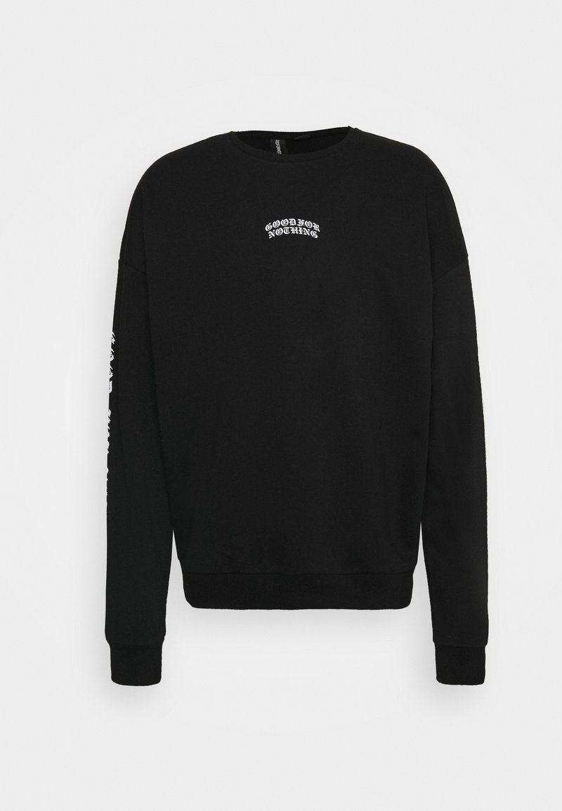 Sweat-shirt noir à manches longues, avec poignets et encolure côtelés. Motif texte blanc sur le devant et la manche. Texture de tissu doux.