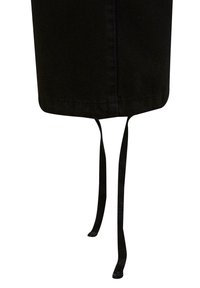 Jupe en tissu noir à coupe droite, dotée de deux liens en tissu en bas pour les ajustements. Texture lisse et design mi-genou.