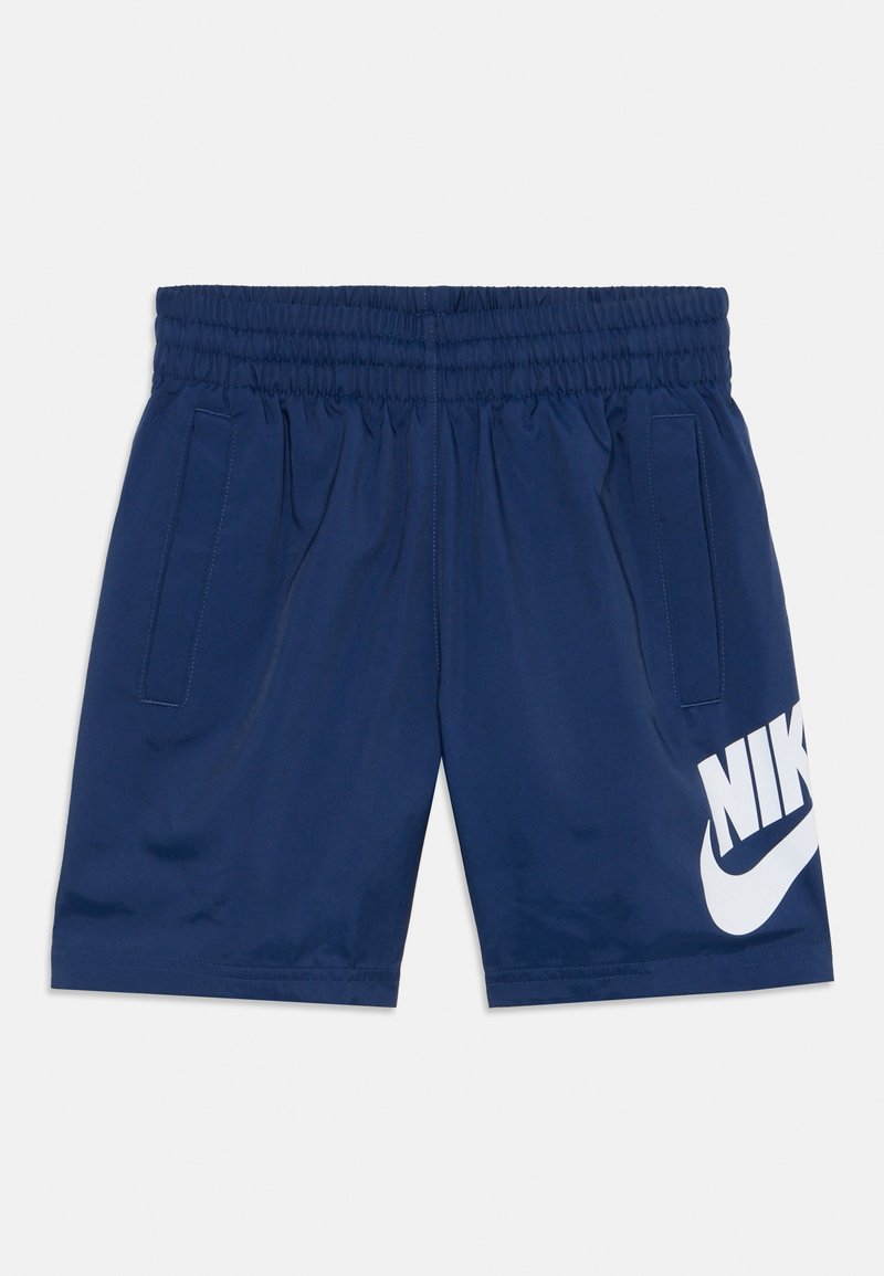 Navy athletic shorts with an elastic waistband, two side pockets, and a prominent white Nike logo on the left leg. Smooth texture.
