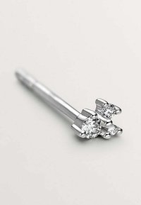 Pendiente de barbell de plata que presenta tres piedras preciosas transparentes en engastes de garra; la piedra más grande está colocada en el centro con dos piedras más pequeñas a los lados.