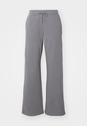Grå joggebukser laget av myk bomullsblanding, med snor i midjen, sidelommer og vidde i bena. Glatt tekstur uten mønstre.