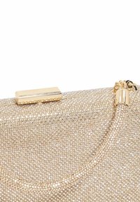 Clutch purse covered in small sparkling gold rhinestones with a gold rectangular clasp and a short strap.