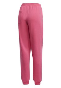 Pantalons de survêtement roses en tissu doux, avec une coupe décontractée, une taille élastique et une poche arrière. Avec des poignets aux chevilles.