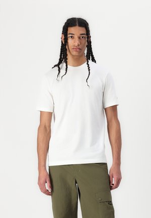 White cotton t-shirt with short sleeves, round neck, and a relaxed fit, paired with olive green cargo pants featuring side pockets.