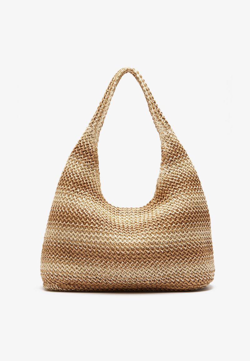 Woven tote bag in natural and beige tones, featuring a rounded shape, wide strap, and open top, crafted from textured straw material.