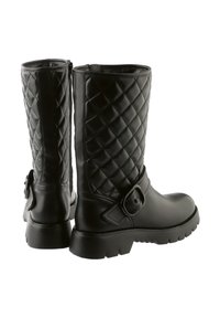 Black mid-calf boots with quilted leather pattern, side zipper, large buckle strap detail, and chunky lug soles, shown from back and side angles.