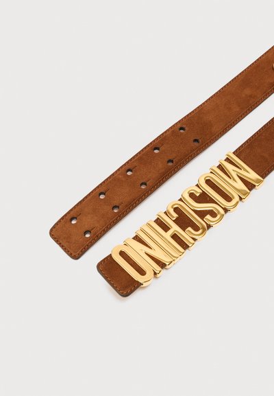 Καφέ σουέντ ζώνη με πολλαπλές τρύπες ρύθμισης και μεγάλα χρυσά γράμματα που σχηματίζουν το "MOSCHINO" ως λεπτομέρεια της αγκράφας.