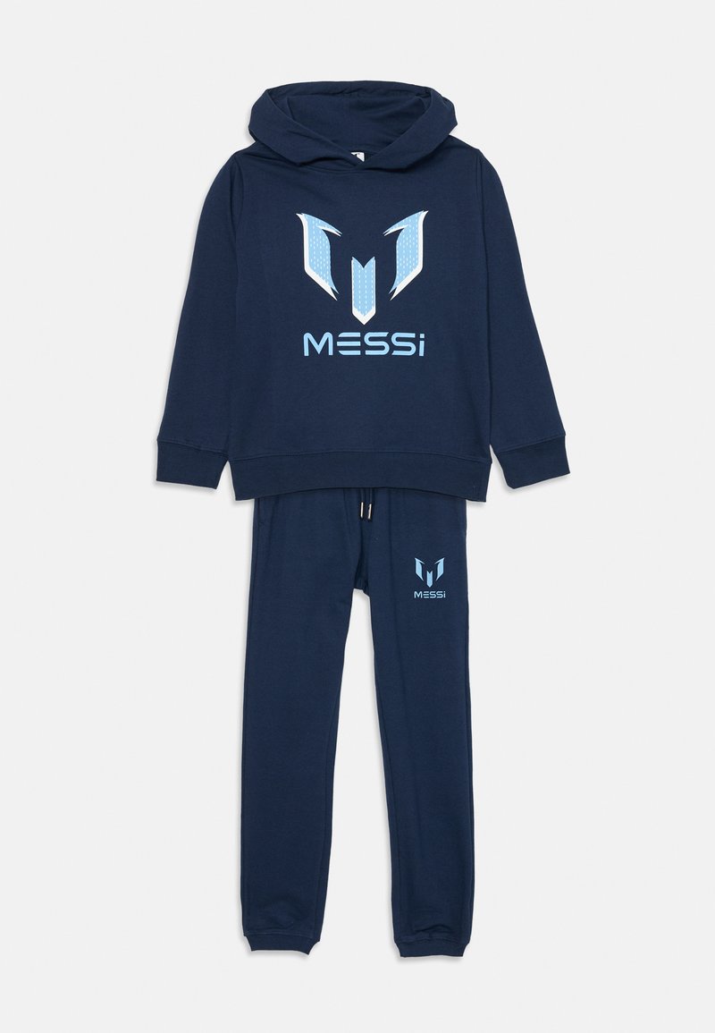 Tamsiai mėlynas džemperis su kelnėmis, pagamintas iš medvilnės, su dideliu stilizuotu šviesiai mėlynu logotipu su akcentais. Su gobtuvu ir gumuotomis rankovėmis.