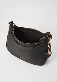 Black leather handbag with a textured surface, gold zipper, and hardware. Features a removable charm and an interior label.