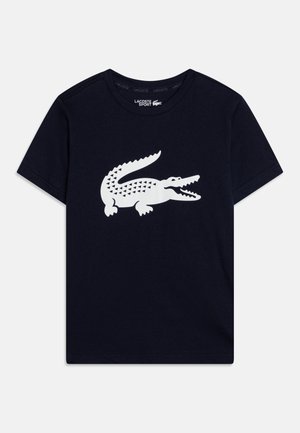 T-shirt en coton bleu marine avec un grand graphique de crocodile blanc à motif, col rond ribbé et manches courtes.