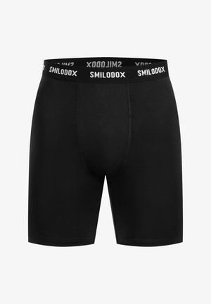 Mustat bokserit, jotka on valmistettu joustavasta kankaasta ja joissa on sileä pinta. Ominaisuuksina valkoisella brändätyllä elastisella vyötärönauhala ja tiukka malli.