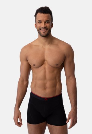 Boxers negros con una cinturilla roja a contraste. Tejido elástico, diseño de tiro medio y detalles sutiles en las costuras que mejoran el ajuste y la comodidad.