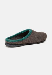 Brown felt slipper with green woven trim, black sole, and slip-on design, isolated on a white background.