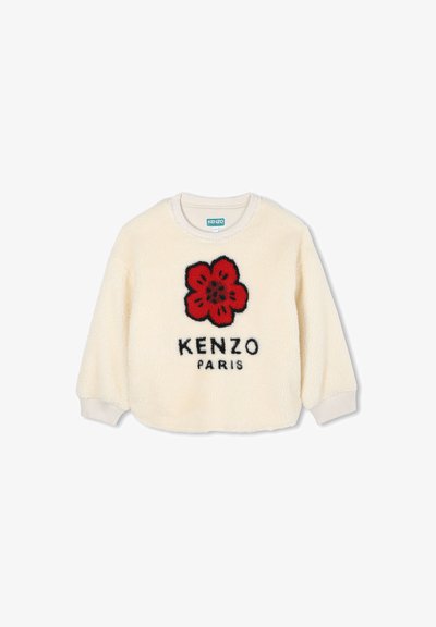 Sweter z kremowego polaru z czerwonym wzorem kwiatu i czarnym napisem "KENZO PARIS". Żebrowane mankiety i dekolt. Miękka faktura.