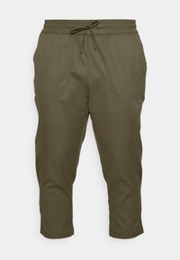 Pantalons cropped vert olive en tissu léger, avec une taille élastique à cordon de serrage et deux poches avant. Texture lisse.