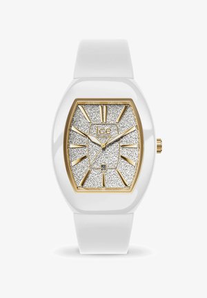 Orologio con cinturino in silicone bianco, quadrante argento con texture scintillante e dettagli dorati, faccia rettangolare e indici dell'ora in evidenza. Visualizzazione della data alle 6.