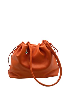 Orange leather handbag with gathered top and long strap, featuring a small hanging charm with an Italian flag design.