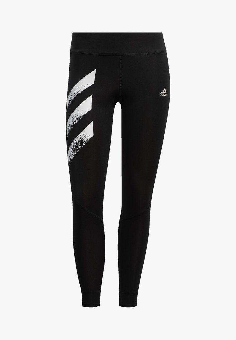 Czarne legginsy wykonane z elastycznego materiału, z białym graficznym wzorem trzech skośnych pasków po lewej stronie oraz logo Adidas na talii.