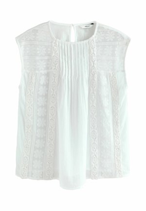 Blouse blanche à manches courtes, ornée de broderies délicates et de détails plissés. Tissu doux avec une fermeture en goutte d'eau au dos.