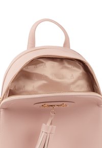 Zaino in pelle rosa chiaro con chiusura zip, accessori dorati e tessuto interno strutturato con un motivo a logo ripetuto.